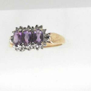 Amethysts Estate Ring 
10 Karat Yellow Amethysts Ring With Finger Size 7 
 Gram Weight 2.3 
3 Center Amethysts Shape: Oval With 21 Round Diamonds