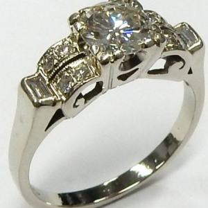 Estate Diamond Engagement Ring 
18 Karat White Estate Engagement Ring 
Finger Size 6.25 Gram Weight 3.6 
1 Center Diamond 0.73ct Shape: Round; Clarity: I1; Colour: H With 10 Various Shapes Diamonds 0.10 ctw 0.83