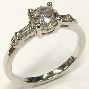 Estate Diamond Engagement Ring 
Platinum White Estate Engagement Ring 
Finger Size 8.5 Gram Weight 5.6 
1 Center Diamond 1.19ct Shape: Round; Clarity: SI1; Colour: I; GIA 2235172574 With 2 Baguette Diamonds 0.175 ctw and 2 Round Diamonds 1.365