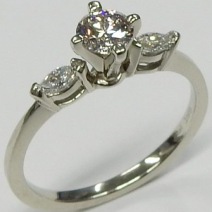 Estate Diamond Engagement Ring 
18 Karat White Estate Engagement Ring Width 1.8mm 
Finger Size 7.5 Gram Weight 2.9 
1 Center Created Diamond (Lab) 0.40ct Shape: Round; Clarity: VVS; Colour: G With 2 Marquise Created Diamond (Lab)s 0.12 ctw 0.52