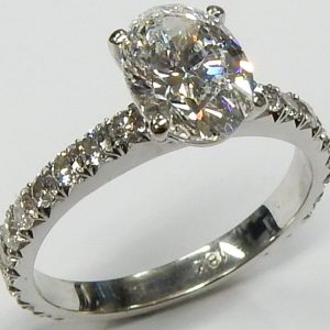 Estate Diamond Engagement Ring 
18 Karat White Estate Engagement Ring Width 2.5mm 
Finger Size 7 Gram Weight 3.4 
1 Center Diamond 1.51ct Shape: Oval; Clarity: SI1; Colour: F; GIA 6215552977 With 22 Round Diamonds 0.66 ctw 2.17