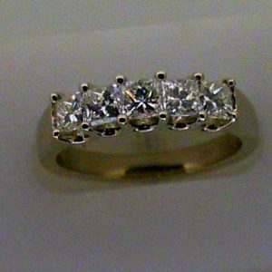 Diamond Wedding/Anniversary Ring
18 Karat White Wedding/Anniversary Ring
Finger Size 6.5 Gram Weight 5.3
5 Center Diamonds Shape: Princess; Clarity: VS; Colour: I 1.03