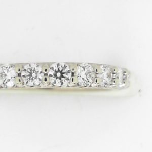 Estate Diamond Anniversary Ring 
14 Karat White Estate Anniversary Ring Width 2.5mm 
Finger Size 5 Gram Weight 2.4 
12 Center Canadian Diamonds 0.06ct Shape: Round; Clarity: VS1; Colour: F 0.72