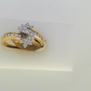 Diamond Dinner Ring - Women's
14 Karat Yellow Dinner Ring
Finger Size 6.5
19 Center Diamonds Shape: Various Shapes Clarity: SI1 Colour: G/H 0.62