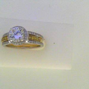 Diamond Semi-Mount Ring 
18 Karat Yellow/White Ring 
Finger Size 7 
 Center Diamond Shape: Round; Clarity: VS1; Colour: F/G Round Diamond 0.20 ctw 0.53