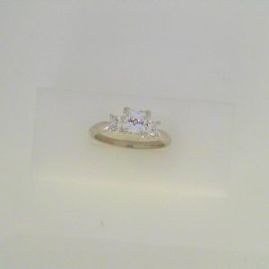Diamond Semi-Mount Ring
14 Karat White Ring Width 1.8mm
Finger Size 7 Gram Weight 3.6
2 Center Diamonds Shape: Princess With 1 Princess Cubic Zirconium 0.43