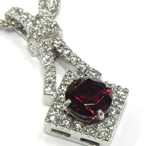 Estate Diamond Pendant/Necklace
18 Karat White Estate Diamond Pendant
Gram Weight 5.1 Chain Style: No Chain
1 Center Garnet Shape: Round With 39 Round Diamonds 0.50 ctw 0.5