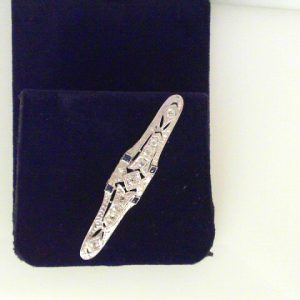 Estate Pins and Brooches 
18 Karat White Estate Pin/Brooch Gram Weight: 5.5 
4 Sapphires Shape: Princess