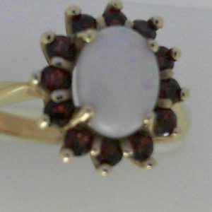 Opal Ring
14 Karat Yellow Opal Ring With Finger Size 6.5
Width 2.2mm Gram Weight 3.81
1 Center Opal Shape: Oval With 12 Round Garnets