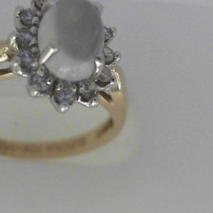 Moonstone Ring
10K/14K Yellow/White Moonstone Ring With Finger Size 6.25
Width 1.96mm Gram Weight 2.79
1 Center Moonstone Shape: Cabochon With 12 Round Diamonds 0.11 ctw