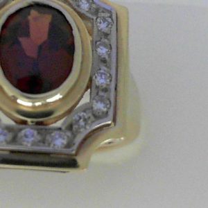Garnet Ring
14 Karat Yellow Garnet Ring With Finger Size 6.75
Width 2.22mm Gram Weight 7.15
1 Center Garnet Shape: Oval With 18 Round Diamonds 0.18 ctw