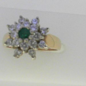 Emerald Ring 
14 Karat Yellow/White Emerald Ring With Finger Size 5.75 
Width 2.15mm Gram Weight 4.03 
1 Center Emerald Shape: Round With 16 Round Diamonds 0.48 ctw