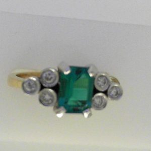 Created Emerald Ring 
14 Karat Yellow/White Created Emerald Ring With Finger Size 6 
Width 2.53mm Gram Weight 3.95 
1 Center Created Emerald Shape: Emerald With 6 Round Diamonds 0.18 ctw