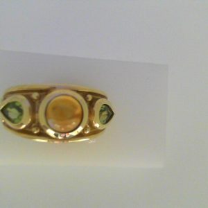Citrine Estate Ring 
14 Karat Yellow Citrine Ring With Finger Size 9 
Width 3.7mm Gram Weight 7.6 
1 Center Citrine Shape: Cabochon With 2 Pear Peridot