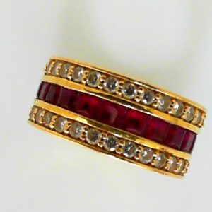 Rubies Estate Ring
18 Karat Yellow Rubies Ring With Finger Size 6.75
Width 9.3mm Gram Weight 10.9
24 Center Rubies Shape: Princess With 60 Round Diamonds 1.50 ctw