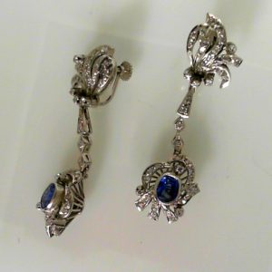 Estate Earrings With Sapphires 
14 Karat White Blue Sapphires Earrings 
 Gram Weight 11.4 
2 Center Sapphires Shape: Oval; Colour: Blue With 10 Round Diamonds 0.80 ctw