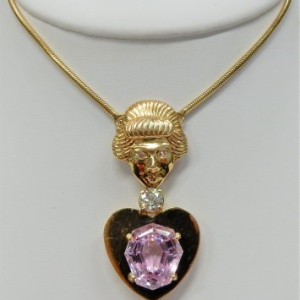Kunzite Estate Pendant
14 Karat Yellow Pink Kunzite Pendant
Gram Weight 36.3 Chain Style: Snake 14 Karat Yellow Length: 30in
1 Center Kunzite 22.00ct Shape: Fantasy Cut; Colour: Pink With 1 Round Diamond 0.92 ctw and 2 Round Diamonds 0.05 ctw