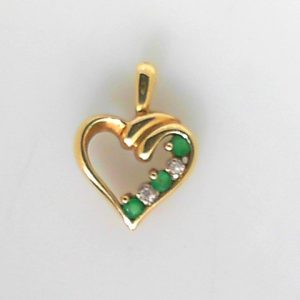 Emeralds Estate Pendant 
10 Karat Yellow Emeralds Pendant 
Gram Weight 1.3 Chain Style: No Chain 
3 Center Emeralds Shape: Round With 2 Round Diamonds