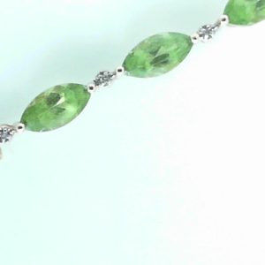 Estate Bracelet With Peridot 
14 Karat Yellow Peridot Bracelet Length: 7in 
Gram Weight 8.1 
12 Center Peridot Shape: Marquise With 12 Round Diamonds