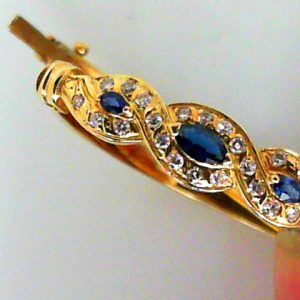 Estate Bracelet With Sapphires
14 Karat Yellow Sapphires Bracelet
Gram Weight 15.87
3 Center Sapphires Shape: Marquise With 23 Round Diamonds 0.33 ctw