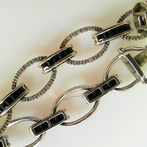 Estate Bracelet With Sapphires
14 Karat White Sapphires Bracelet Length: 7.5in
Gram Weight 17.4
50 Center Sapphires Shape: Princess With 178 Round Diamonds 0.66 ctw