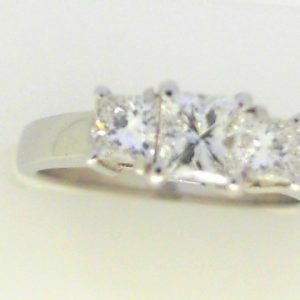 Diamond Engagement Ring 
18 Karat White Engagement Ring 1twt
Finger Size 6.5 Gram Weight 5gram weight Width: 2.6 
1 Center Diamond 0.51ct Shape: Princess Clarity: SI1 Colour: G With 2 Princess Diamonds 0.49 ctw 1