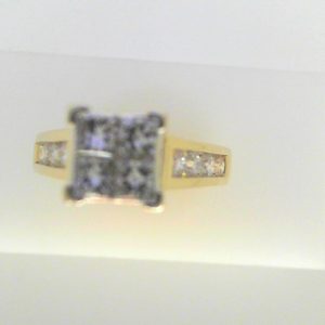 Estate Diamond Engagement Ring 
14 Karat Yellow Estate Engagement Ring 
Finger Size 6.5 Gram Weight 5.8 
4 Center Diamonds Shape: Princess; Clarity: SI1; Colour: I With 8 Round Diamonds 0.60 ctw 1.25