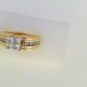 Estate Diamond Engagement Ring 
14 Karat Yellow Estate Engagement Ring 
 Gram Weight 5.1 
4 Center Diamonds Shape: Princess With 10 Round Diamonds 0.30 ctw 0.7
