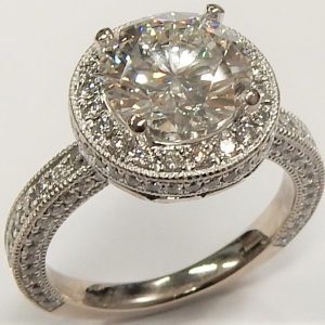 Estate Diamond Engagement Ring 
18 Karat White Estate Engagement Ring 
 Gram Weight 6.1 
1 Center Diamond 2.20ct Shape: Round; Clarity: VS2; Colour: H; GIA 1122960328 With 129 Round Diamonds 0.75 ctw 2.95