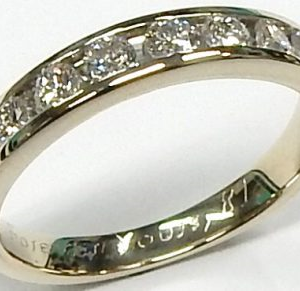 Estate Diamond Anniversary Ring 
14 Karat White Estate Anniversary Ring 
Finger Size 4.5 Gram Weight 2.2 
 Center Diamond Shape: Round; Clarity: SI2; Colour: G 0.5