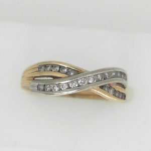 Estate Diamond Anniversary Ring 
10 Karat Yellow/White Estate Anniversary Ring 
Finger Size 7 Gram Weight 2.79 
23 Center Diamonds Shape: Round 0.25