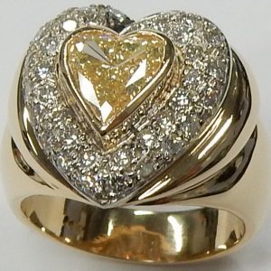Estate Diamond Dinner Ring - Women's 
14 Karat Yellow/White Estate Dinner Ring 
Finger Size 6.5 Gram Weight 8.9 
34 Center Diamonds Shape: Round; Clarity: SI1; Colour: H/I Heart Diamond 0.91 ctw 1.31