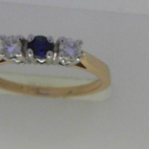 Sapphire Ring
14 Karat Yellow/White Sapphire Ring With Finger Size 6
Width 1.46mm Gram Weight 2.26
1 Center Sapphire Shape: Round With 2 Round Diamonds 0.17 ctw