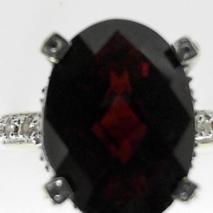 Garnet Estate Ring 
14 Karat Yellow Garnet Ring With Finger Size 6 
 Gram Weight 5.3 
1 Center Garnet Shape: Oval With 6 Round Diamonds