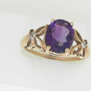 Amethyst Estate Ring 
10 Karat Yellow Amethyst Ring With Finger Size 9.25 
 Gram Weight 2.77 
1 Center Amethyst Shape: Oval With 2 Round Diamonds