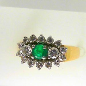 Birks Emerald Estate Ring 
18 Karat Yellow Emerald Ring With Finger Size 6.5 
 Gram Weight 5.3 
1 Center Emerald Shape: Round With 16 Round Diamonds 0.60 ctw