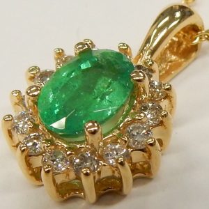 Emerald Estate Pendant 
14 Karat Yellow Emerald Pendant 
Gram Weight 1.9 Chain Style: No Chain 
1 Center Emerald 0.68ct Shape: Oval With 14 Round Diamonds 0.30 ctw