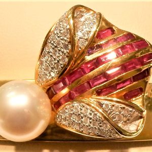 Estate Bracelet With Pearl 
18 Karat Yellow White Pearl Bracelet Width: 13mm 
Gram Weight 56 
1 Center Pearl Shape: Round; Clarity: GOOD; Colour: White With 22 Baguette Rubies 3.02 ctw and 54 Round Diamonds 0.77 ctw