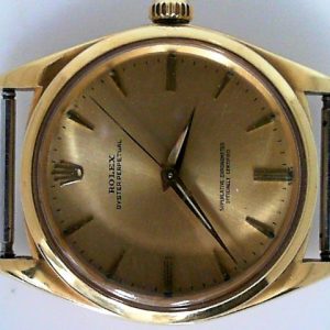 Estate Rolex Dress Year: 1961
Vendor Style #: 1012 Oyster Perpetual smooth bezel SN: 737398 Strap
36mm 18 Karat
Dial: Champagne arrowhead 
Box Not Included/Papers Not Included
Condition Good
1 Year Warranty