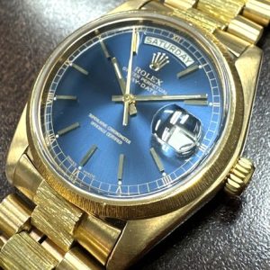 Estate Rolex Dress Year: 1982
Vendor Style #: 18078 Day-Date Blue Bark SN: 7341834 Bracelet
36mm 18 Karat
Dial: Blue hash 
Box Not Included/Papers Not Included
Condition Good, 21 link, 129.4 gram.
1 Year Warranty