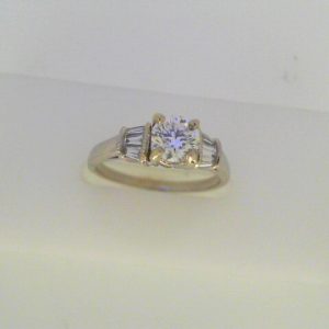 Diamond Engagement Ring 
14 Karat White Engagement Ring 0.8twt
Finger Size 5.5 Gram Weight 2.8gram weight Width: 1.6 
1 Center Diamond 0.56ct Shape: Round Clarity: VS1 Colour: I With 6 Baguette Diamonds 0.24 ctw 0.8