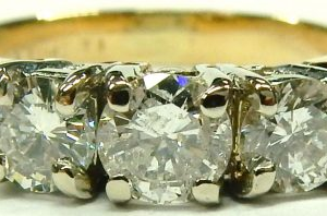 Estate Diamond Engagement Ring 
14 Karat Yellow/White Estate Engagement Ring Width 2.78mm 
Finger Size 5.25 Gram Weight 3.9 
3 Center Diamonds Shape: Round; Clarity: I1; Colour: J 0.87