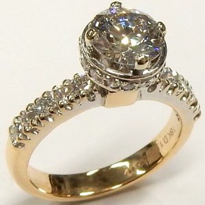 Estate Diamond Engagement Ring 
18 Karat Yellow/White Estate Engagement Ring 
Finger Size 4.5 Gram Weight 4.5 
1 Center Diamond 1.00ct Shape: Round; Clarity: VS1; Colour: G; GIA 6275113242 With 35 Round Diamonds 0.52 ctw 1.52