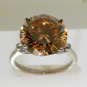Ladies platinum diamond ring containing 6.05ct. I1 fancy brown diamond ring with baguette shoulder accents 3.26 grams.