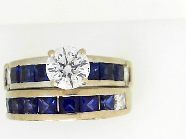 Estate Diamond Engagement Ring
14 Karat White Estate Engagement Ring
Finger Size 7.5 Gram Weight 12.1
1 Center Diamond 1.00ct Shape: Round; Clarity: I1; Colour: D With 4 Princess Diamonds 0.60 ctw and 13 Princess Sapphires 2.08 ctw 3.68