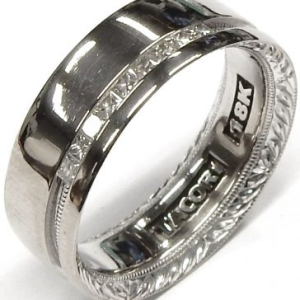 Estate Diamond Ring - Men's 
18 Karat White Estate Diamond Ring Width 6.7mm 
Finger Size 6.75 Gram Weight 8 
9 Center Diamonds Shape: Princess; Clarity: VS1; Colour: G 0.25