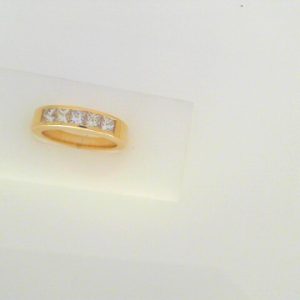 Diamond Wedding/Anniversary Ring 
18 Karat Yellow Wedding/Anniversary Ring 
Finger Size 6.5 Gram Weight 7.4 
5 Center Diamonds Shape: Princess; Clarity: VS; Colour: I 1.03