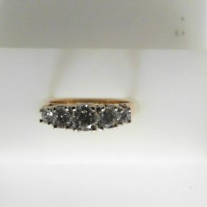 Estate Diamond Anniversary Ring 
18 Karat Yellow Estate Anniversary Ring 
Finger Size 5.25 Gram Weight 3.63 
5 Center Diamonds Shape: Round; Clarity: SI2; Colour: H/I 0.75