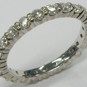 Estate Diamond Anniversary Ring 
18 Karat White Estate Anniversary Ring Width 2.5mm 
Finger Size 6.5 Gram Weight 2.9 
23 Center Diamonds Shape: Round; Clarity: VS; Colour: I 1.38