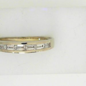 Estate Diamond Anniversary Ring 
14 Karat White Estate Anniversary Ring 
Finger Size 8.5 Gram Weight 3.03 
7 Center Diamonds Shape: Baguette; Clarity: VS; Colour: F/G 0.5